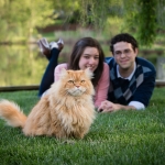 Couple lying on the grass with their cat | Anne Lord Photography