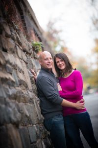 Couple leaning against wall